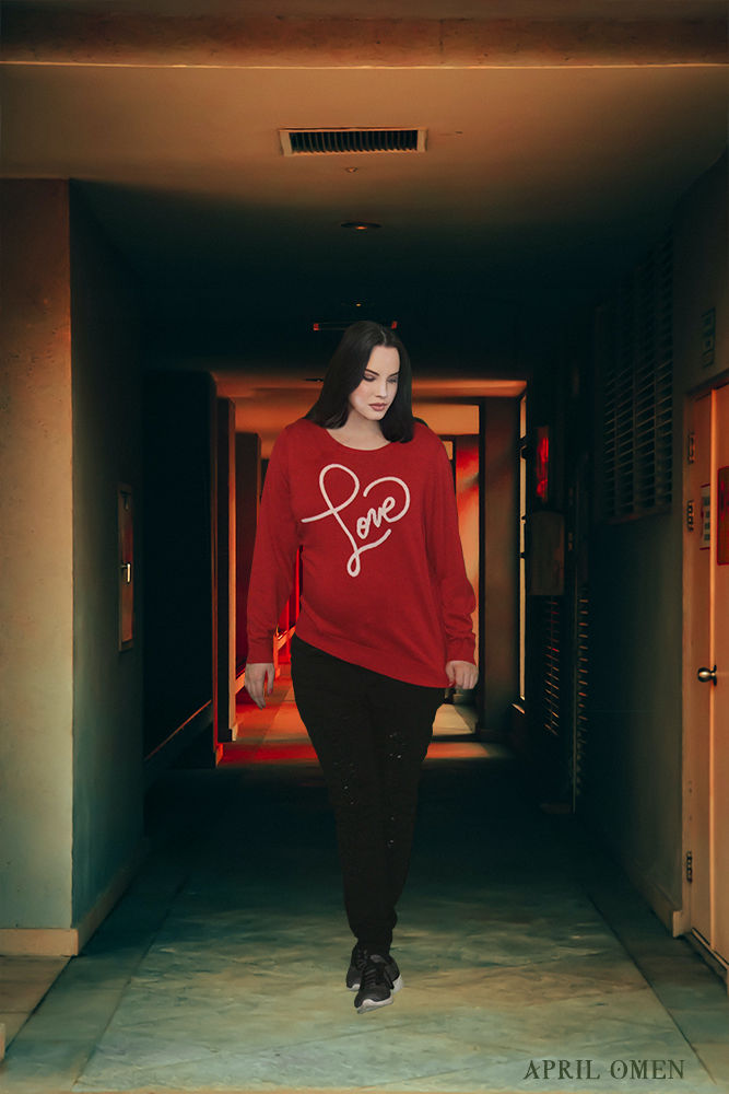 A photograph of April Omen, she is wearing a red sweater