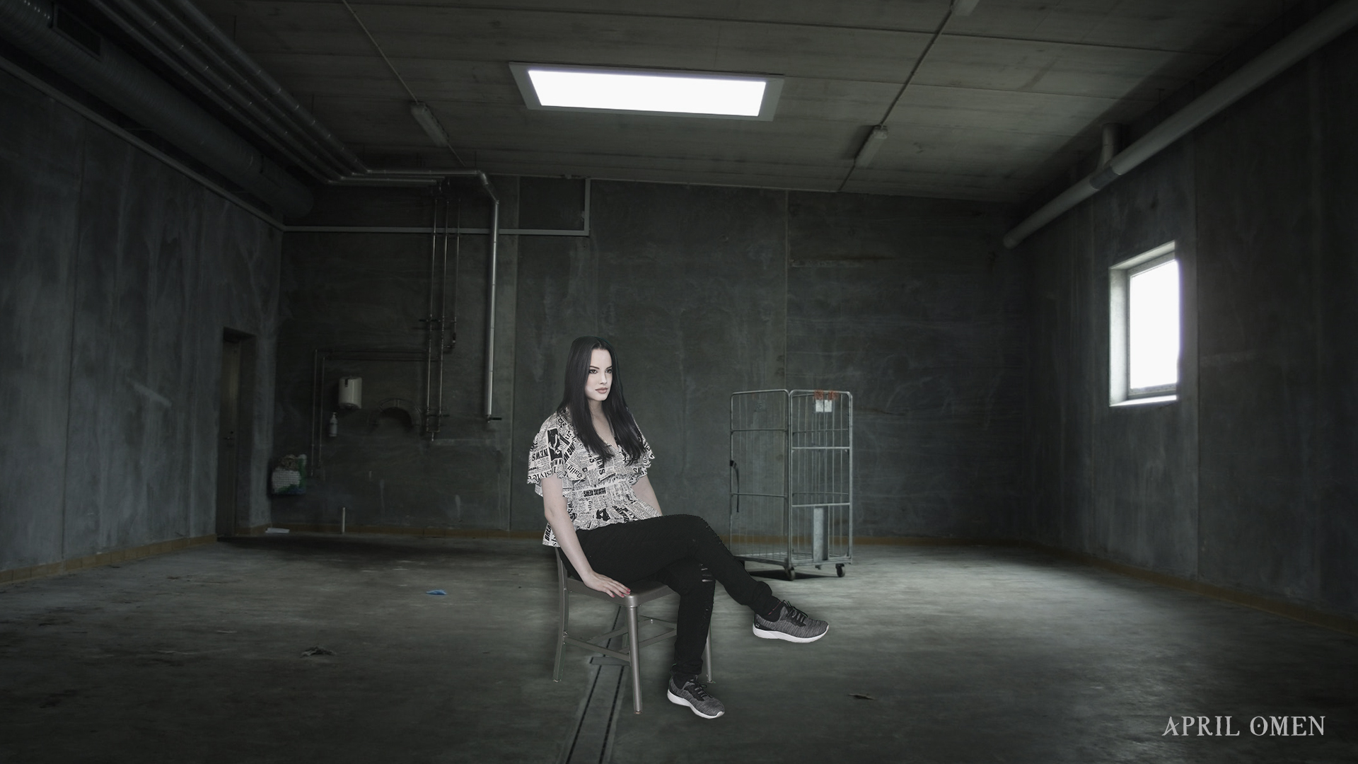 April Omen is sitting in a chair inside a warehouse